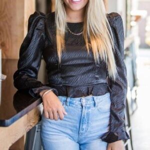 Tigerprint black top. Ruffle hem.